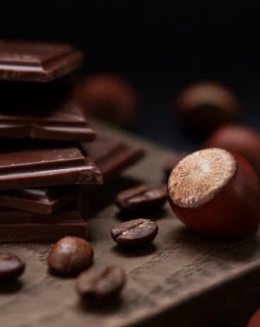 chocolate, coffee beans and chestnuts on the wood table